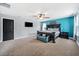 Main bedroom with accent wall, large ceiling fan, large bed and carpet at 18566 Hunters Meadow Walk, Land O Lakes, FL 34638