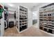 Organized walk-in closet with shelves, hanging rods, and a glimpse of the en-suite bathroom at 18566 Hunters Meadow Walk, Land O Lakes, FL 34638