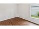 Cozy bedroom featuring wood floors and a bright window view at 18916 New Passage Blvd, Land O Lakes, FL 34638