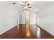 Primary bedroom featuring hardwood floors, a ceiling fan, and access to the ensuite at 18916 New Passage Blvd, Land O Lakes, FL 34638
