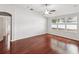 Spacious bedroom with wood floors, a ceiling fan, and three windows at 18916 New Passage Blvd, Land O Lakes, FL 34638