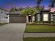 Beautiful single-story home with well-maintained landscaping and a two-car garage at 18916 New Passage Blvd, Land O Lakes, FL 34638