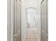 Hallway with wood-look tile leading to an ensuite bathroom at 18916 New Passage Blvd, Land O Lakes, FL 34638