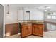 Open kitchen with granite counters flows to the living room with hardwood floors at 18916 New Passage Blvd, Land O Lakes, FL 34638