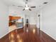 Hardwood floor living room with open concept to kitchen and dark door at 18916 New Passage Blvd, Land O Lakes, FL 34638
