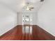 Living room space featuring hardwood floors and a bright bay window at 18916 New Passage Blvd, Land O Lakes, FL 34638
