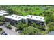 A bird's-eye view of the condominium building complex, nestled amid green golf course, lush trees, and scenic landscaping at 1934 Golfview Dr # 1934, Tarpon Springs, FL 34689