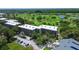 Aerial view showing the condominium's prime location amidst a golf course, water features, and ample parking at 1934 Golfview Dr # 1934, Tarpon Springs, FL 34689