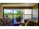 Relaxing balcony with outdoor seating offering scenic views of lush green space with golf course, water and trees at 1934 Golfview Dr # 1934, Tarpon Springs, FL 34689