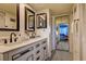 Elegant bathroom showcasing a double sink vanity, decorative mirrors, and unique tile flooring at 1934 Golfview Dr # 1934, Tarpon Springs, FL 34689