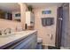 Bathroom boasts quartz counters, integrated sink, a well-lit vanity mirror, and a shower with marble-style walls at 1934 Golfview Dr # 1934, Tarpon Springs, FL 34689