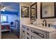 Bathroom boasts double sink vanity, framed mirrors, with connecting bedroom view at 1934 Golfview Dr # 1934, Tarpon Springs, FL 34689