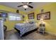 A cozy bedroom featuring neutral flooring, yellow walls, and decoratively-framed wall art for an inviting space at 1934 Golfview Dr # 1934, Tarpon Springs, FL 34689
