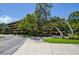 Exterior shot of the building with a beautiful well-maintained landscape, including mature trees and manicured shrubs at 1934 Golfview Dr # 1934, Tarpon Springs, FL 34689