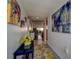 Bright hallway with colorful art leading to an open living area at 1934 Golfview Dr # 1934, Tarpon Springs, FL 34689