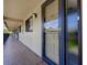 Exterior hallway showcases the entrance to unit 1934, including a storm door, windows, and a secure entrance at 1934 Golfview Dr # 1934, Tarpon Springs, FL 34689