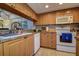 Functional kitchen design with light wood cabinetry and essential appliances at 1934 Golfview Dr # 1934, Tarpon Springs, FL 34689