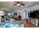 Open-concept living area with comfortable seating, a ceiling fan, and seamless flow into the dining and kitchen spaces at 1934 Golfview Dr # 1934, Tarpon Springs, FL 34689