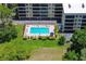 Overhead shot of community pool with furniture and landscaping enhancing the outdoor space at 1934 Golfview Dr # 1934, Tarpon Springs, FL 34689