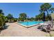 Community pool with lounge chairs and tables creating a relaxing outdoor space for residents at 1934 Golfview Dr # 1934, Tarpon Springs, FL 34689
