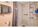 A shower with marble-style walls, built-in shelves, and a shower curtain for a clean, modern look at 1934 Golfview Dr # 1934, Tarpon Springs, FL 34689