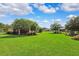 Sprawling backyard featuring a lush lawn, mature trees, and meticulous landscaping, providing a serene retreat at 19531 Mossy Oak Ct, Brooksville, FL 34601