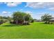 Expansive backyard showcasing a lush green lawn, mature trees, and meticulous landscaping for a serene retreat at 19531 Mossy Oak Ct, Brooksville, FL 34601
