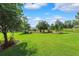 Spacious backyard featuring lush green grass, mature trees, and a charming gazebo, creating a serene outdoor space at 19531 Mossy Oak Ct, Brooksville, FL 34601