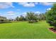 Expansive backyard featuring lush green grass, mature trees, and a charming gazebo, creating a serene outdoor space at 19531 Mossy Oak Ct, Brooksville, FL 34601