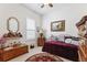bedroom with iron bed, chest, and whimsical touches at 19531 Mossy Oak Ct, Brooksville, FL 34601