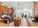 Bright kitchen with stainless steel appliances, wood cabinets, island, and granite countertops overlooking dining area at 19531 Mossy Oak Ct, Brooksville, FL 34601