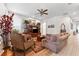 Cozy living room with hardwood floors, a ceiling fan, and traditional decor at 19531 Mossy Oak Ct, Brooksville, FL 34601