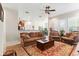 Inviting living room with wood floors, a large ceiling fan, and open view to the kitchen at 19531 Mossy Oak Ct, Brooksville, FL 34601