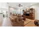 Comfortable living room featuring wood floors, ceiling fan, and furniture at 19531 Mossy Oak Ct, Brooksville, FL 34601