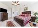 Spacious Primary bedroom featuring a ceiling fan, shutters, and en-suite bathroom at 19531 Mossy Oak Ct, Brooksville, FL 34601