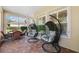 This outdoor patio features hanging chairs, windows, and a seating area for relaxing and entertaining at 19531 Mossy Oak Ct, Brooksville, FL 34601
