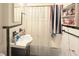 A bathroom featuring a vanity, sink, mirror, shower with a curtain and storage shelf at 2016 Woodward Ave, Dunedin, FL 34698
