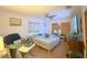 This cozy bedroom features a ceiling fan, wood floors, and natural light at 2016 Woodward Ave, Dunedin, FL 34698
