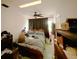 View of the bedroom features a ceiling fan, window with curtains and a bed with patterned bedspread at 2016 Woodward Ave, Dunedin, FL 34698