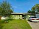 Charming single-story home features a well-maintained lawn and a private driveway at 2016 Woodward Ave, Dunedin, FL 34698