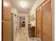 Bright hallway with laminate floors and large, mirrored closet doors at 2016 Woodward Ave, Dunedin, FL 34698