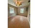 Comfortable bedroom featuring tile flooring, ceiling fan and natural light streaming through large windows at 2234 Marietta Ave, Spring Hill, FL 34608