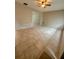 Spacious living room featuring neutral walls, tiled floors, a ceiling fan, and abundant natural light at 2234 Marietta Ave, Spring Hill, FL 34608