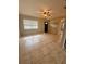Bright living area features tile flooring, a ceiling fan and natural light streaming through the front windows at 2234 Marietta Ave, Spring Hill, FL 34608