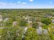 An aerial view showcases a charming neighborhood filled with mature trees and well-maintained homes at 2310 Augusta Dr, Spring Hill, FL 34606