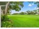 Expansive backyard featuring a well-manicured lawn and mature shade trees at 2310 Augusta Dr, Spring Hill, FL 34606