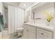 Clean bathroom featuring a shower with bathtub, vanity, framed mirror, and stylish decor at 2310 Augusta Dr, Spring Hill, FL 34606
