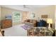 Cozy bedroom featuring a comfortable couch, ceiling fan, and natural light from the window at 2310 Augusta Dr, Spring Hill, FL 34606