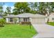 Charming single-story home featuring a well-manicured lawn and a two-car garage at 2310 Augusta Dr, Spring Hill, FL 34606