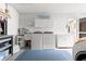 Functional laundry room with washer, dryer, sink, and ample storage space at 2310 Augusta Dr, Spring Hill, FL 34606